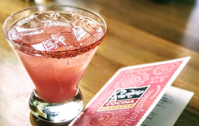 A pink margarita in a glass